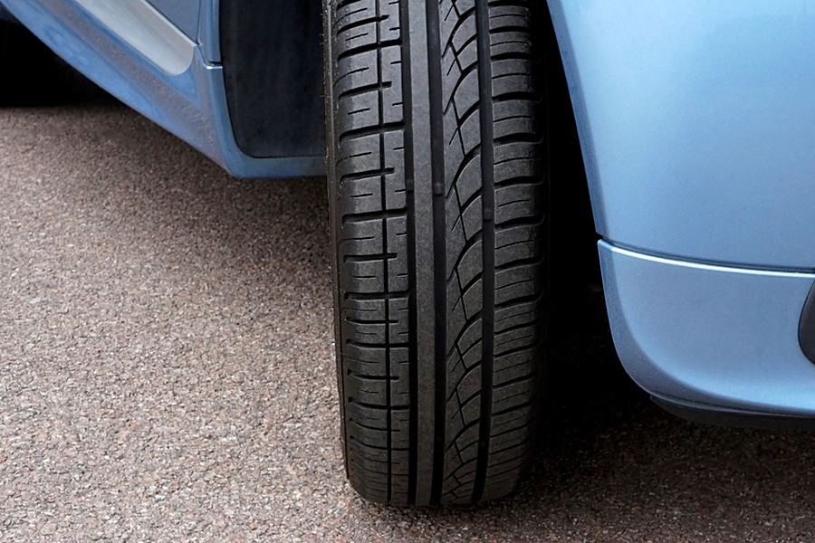 Close-up of a car's front tire on the road